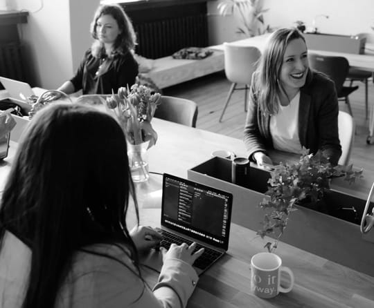 3 people working on their laptop in an openspace or coworking space